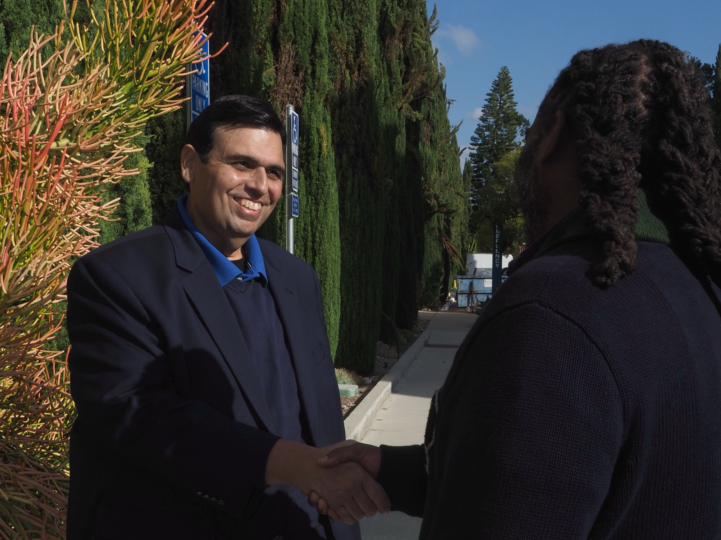 Jose Preciado greeting a Chula Vista resident outdoors