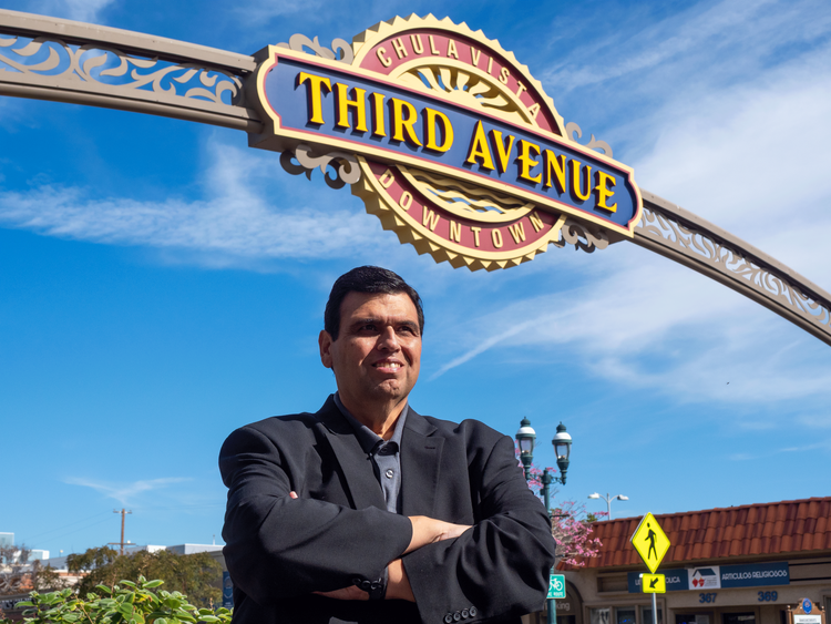 Jose Preciado beneath the Third Avenue sign in Chula Vista